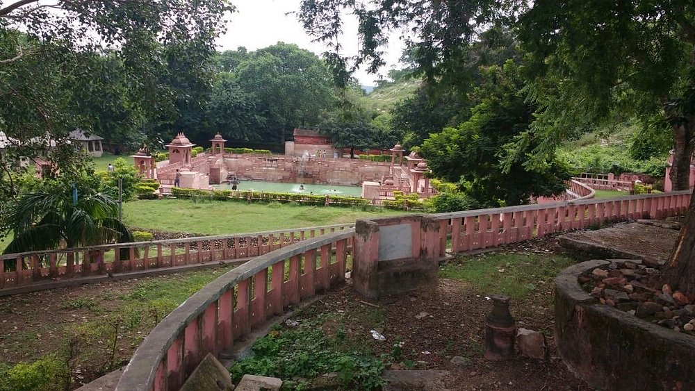 The steaming natural hot springs of Brahmakund in Rajgir with traditional architecture.