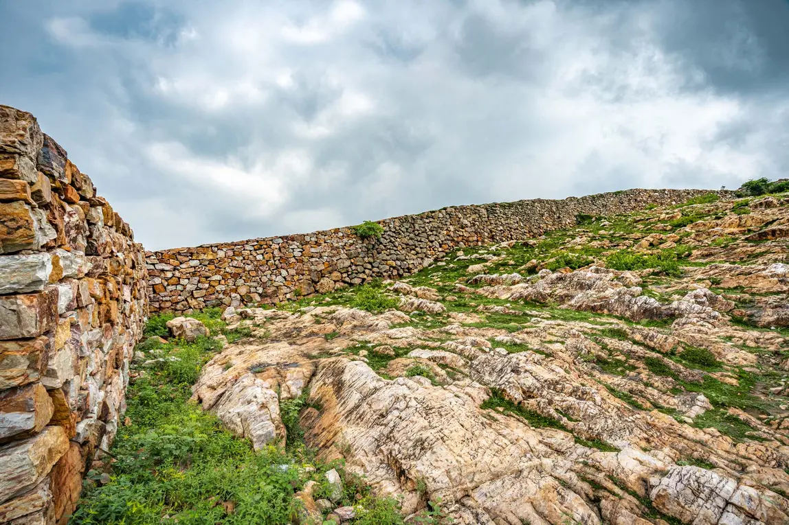 Ancient Cyclopean Wall showcasing prehistoric stone engineering in Rajgir Hills.